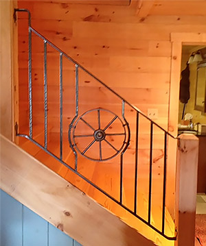 Railing with a wheel from a wheelbarrow